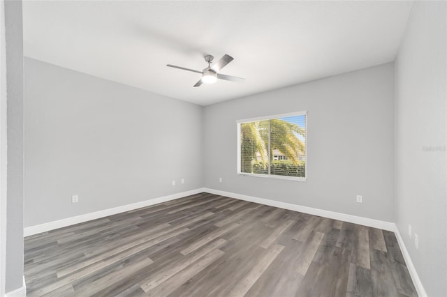 empty room with ceiling fan and dark hardwood / wood-style flooring