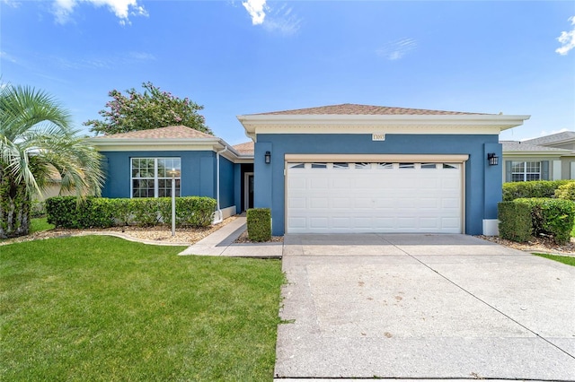 view of front of home featuring a garage and a front lawn