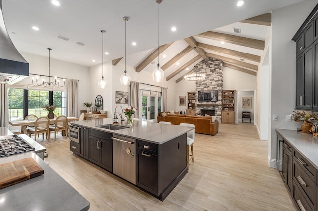 kitchen featuring pendant lighting, an inviting chandelier, sink, stainless steel dishwasher, and beam ceiling