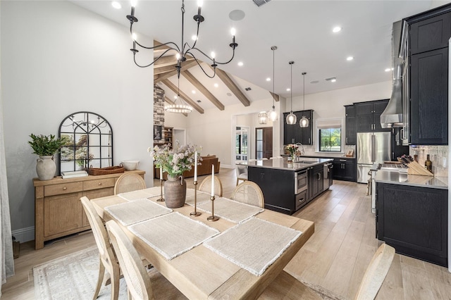 dining room featuring high vaulted ceiling, sink, beamed ceiling, light hardwood / wood-style floors, and a chandelier