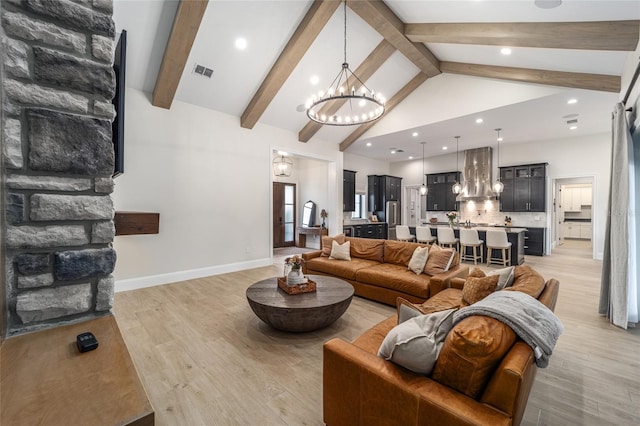 living room with beamed ceiling, high vaulted ceiling, light hardwood / wood-style flooring, and a notable chandelier