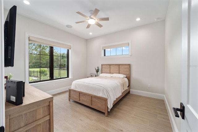 bedroom with light hardwood / wood-style floors and ceiling fan