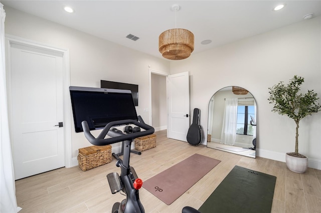 exercise area featuring recessed lighting, visible vents, and wood finished floors