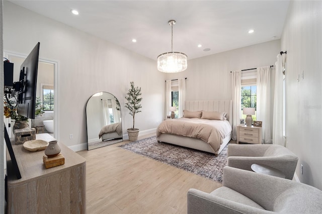 bedroom featuring a chandelier and light hardwood / wood-style floors