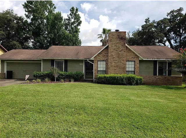 single story home featuring a garage and a front yard