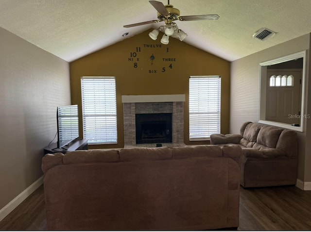 living room with a fireplace, dark hardwood / wood-style floors, a textured ceiling, lofted ceiling, and ceiling fan