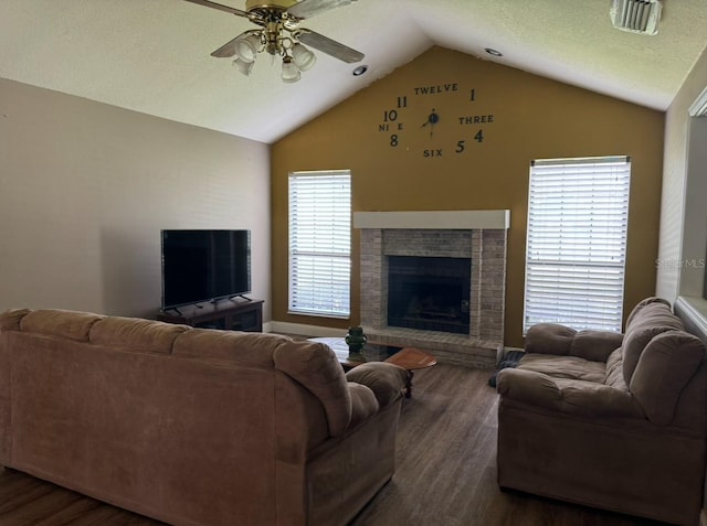 living room with lofted ceiling, wood-type flooring, and a brick fireplace