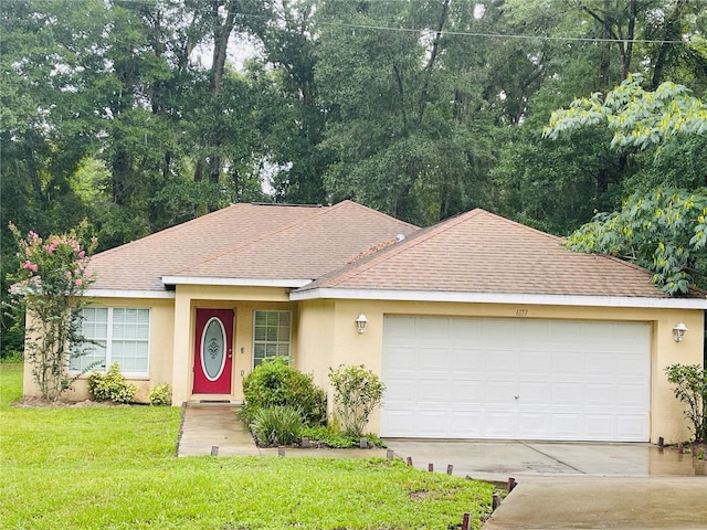 single story home with a front yard and a garage