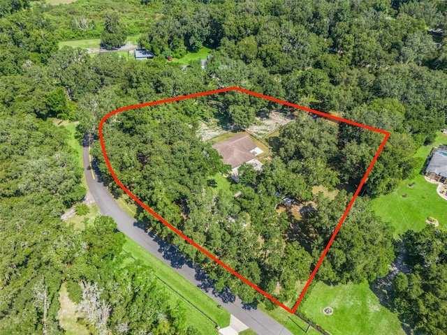 birds eye view of property featuring a forest view