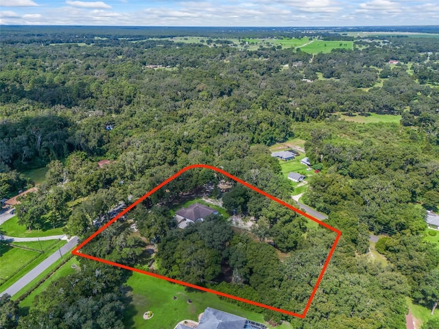 birds eye view of property with a view of trees