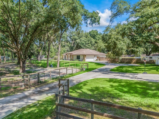 exterior space with concrete driveway and fence