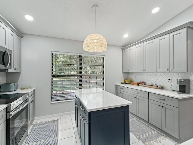 kitchen featuring decorative backsplash, stainless steel appliances, light countertops, and gray cabinetry