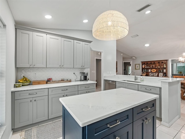 kitchen with a peninsula, a sink, visible vents, stainless steel dishwasher, and an inviting chandelier