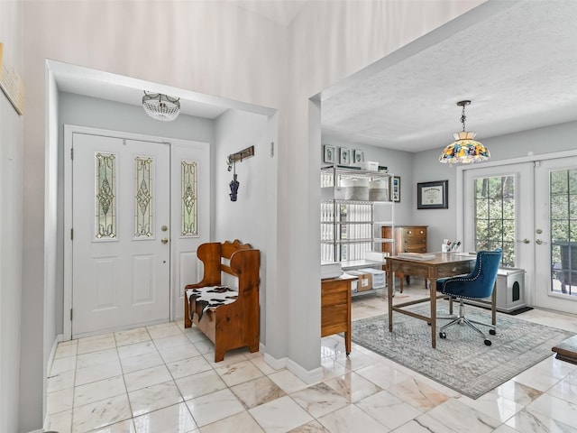 entryway with french doors, a textured ceiling, baseboards, and marble finish floor