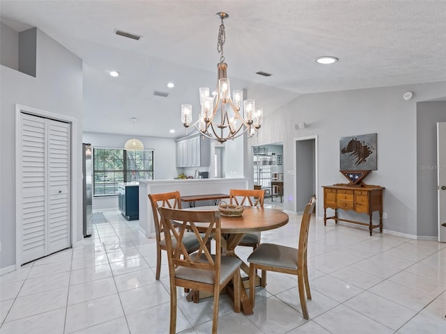 dining area featuring light tile patterned floors, visible vents, vaulted ceiling, a textured ceiling, and baseboards