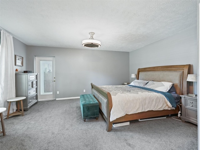 carpeted bedroom with a textured ceiling and baseboards