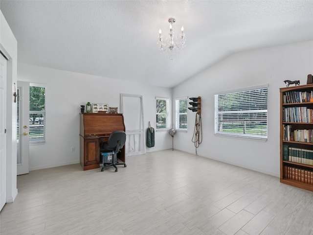 office space featuring vaulted ceiling, a textured ceiling, light wood-style flooring, and a notable chandelier