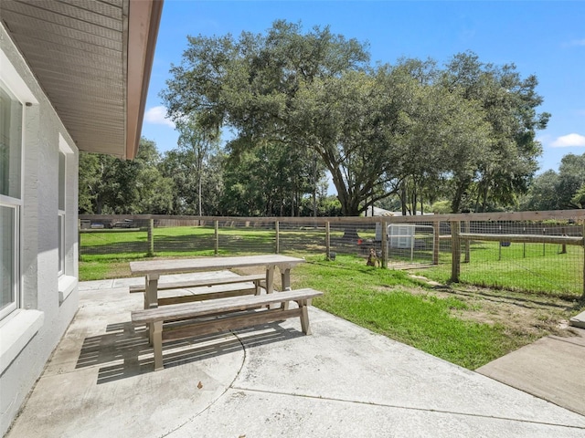 view of community featuring a yard, a patio, and fence