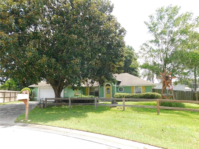 view of front of house with a garage and a front lawn