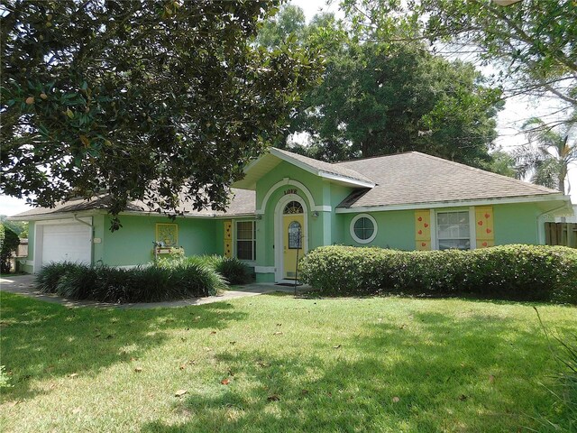 ranch-style home with a garage and a front lawn