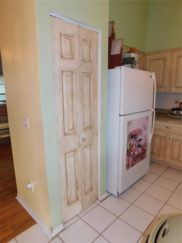 kitchen featuring light hardwood / wood-style floors, white refrigerator, and light brown cabinetry