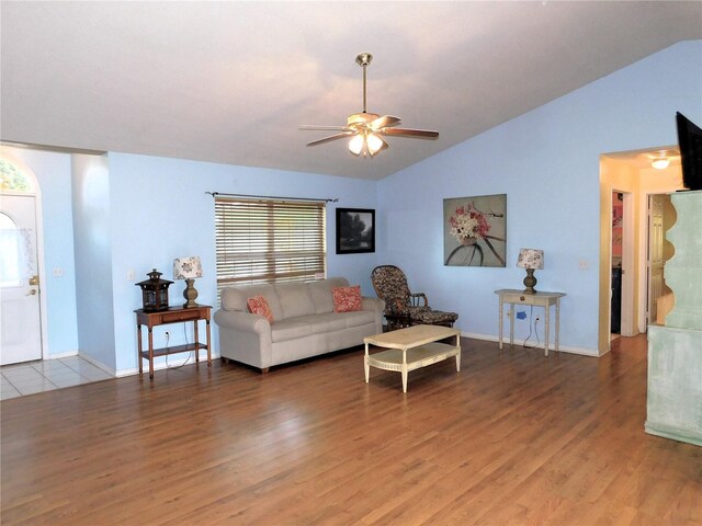 living room featuring wood-type flooring, vaulted ceiling, and ceiling fan