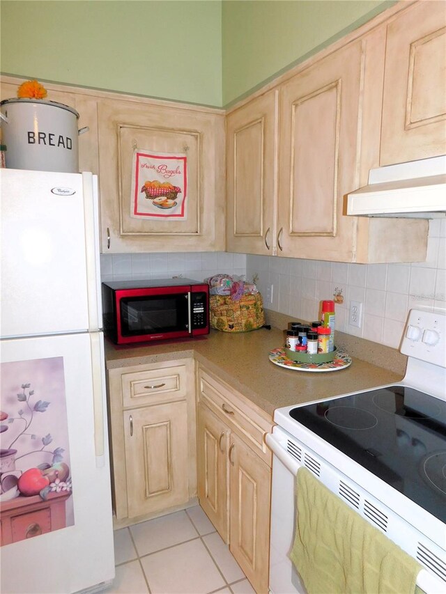 kitchen featuring light tile patterned flooring, decorative backsplash, light brown cabinets, and white appliances