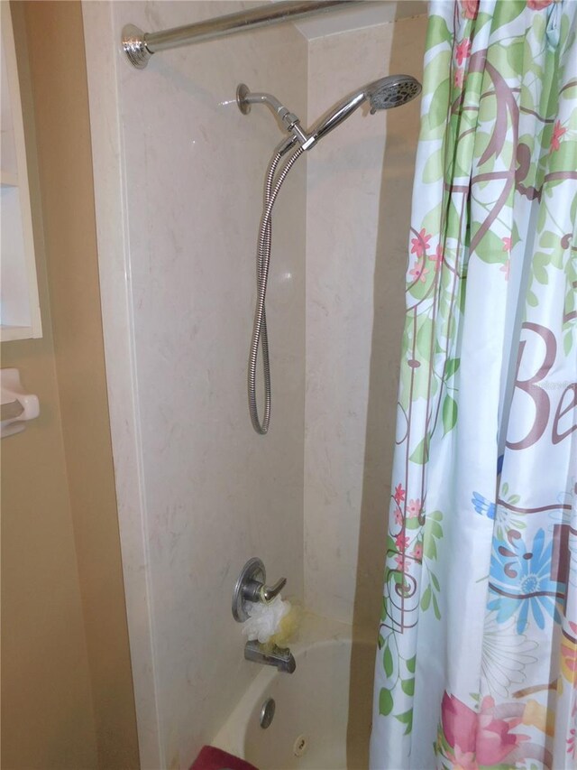 bathroom featuring shower / tub combo with curtain