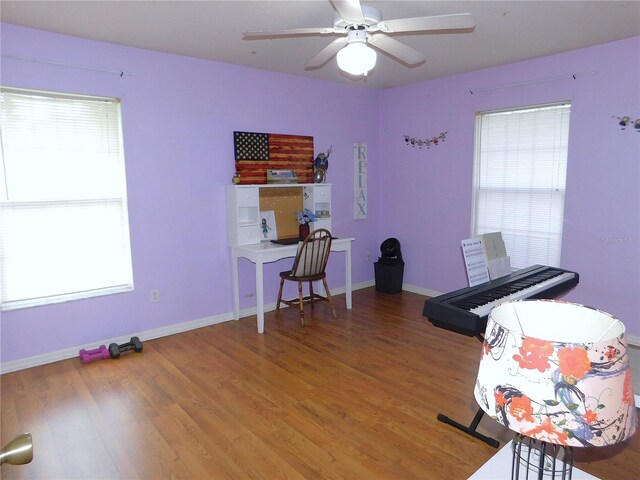 misc room with wood-type flooring and ceiling fan