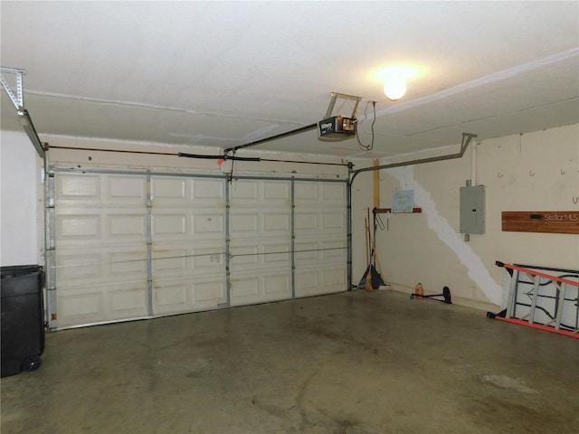 garage with a garage door opener and electric panel