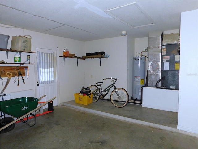 garage featuring heating unit and water heater