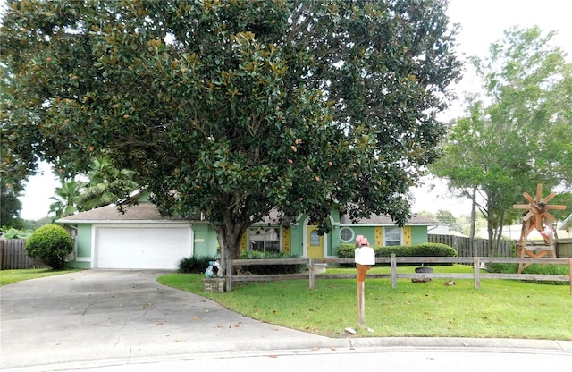 view of front of home with a garage and a front yard