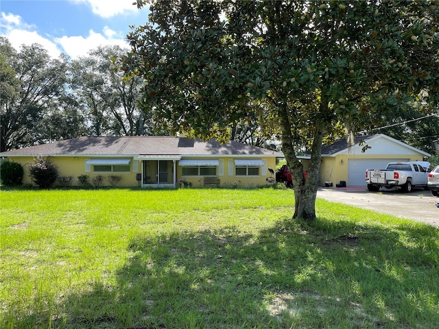 ranch-style house featuring a garage and a front yard