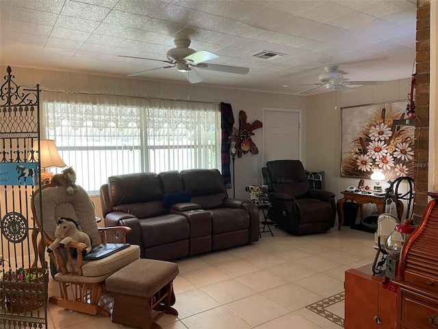 tiled living room featuring ceiling fan