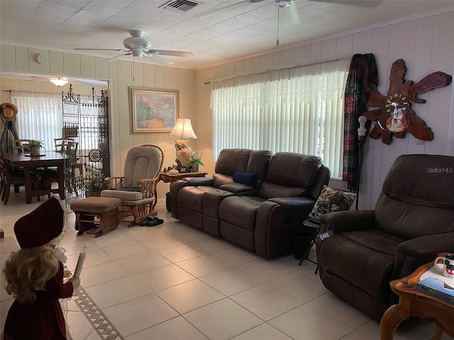 tiled living room with ceiling fan