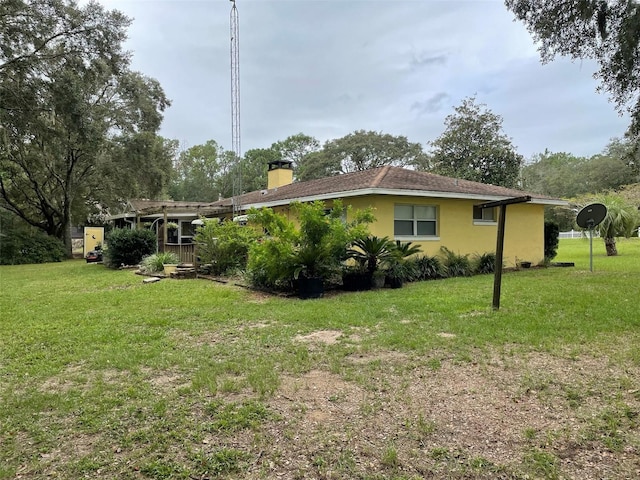 view of side of property featuring a yard