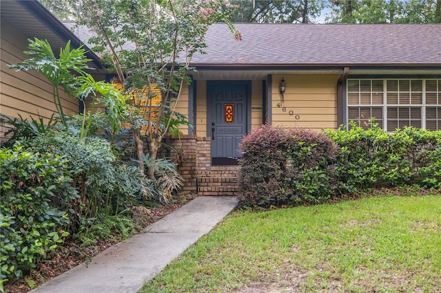 entrance to property with a yard