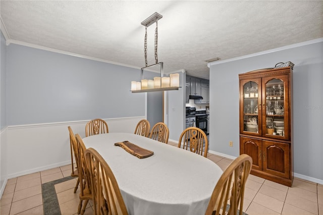 tiled dining space with crown molding and a textured ceiling