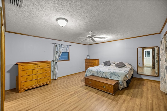 bedroom with light wood-type flooring, ceiling fan, ornamental molding, and a textured ceiling