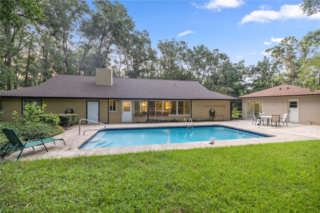 view of pool featuring a yard and a patio