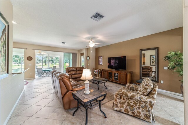 tiled living room featuring ceiling fan