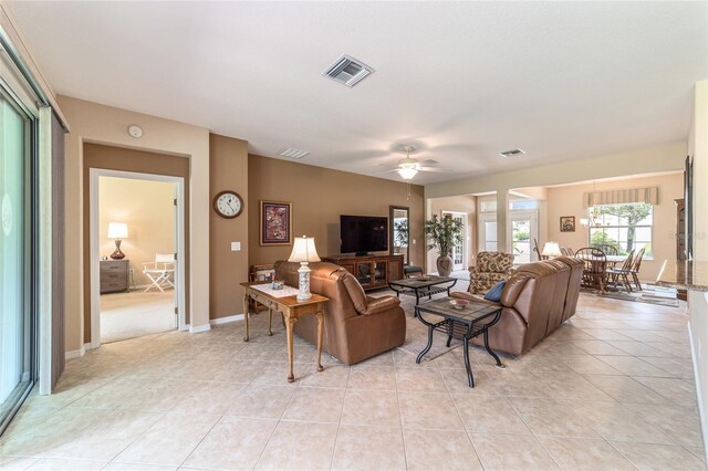 living room featuring light tile patterned floors and ceiling fan