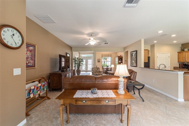 living room with ceiling fan and light tile patterned flooring