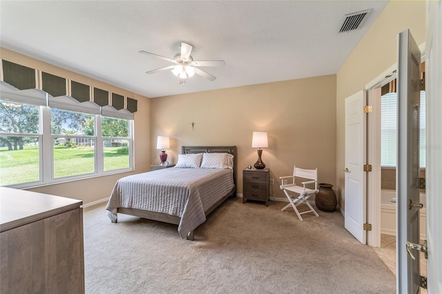 bedroom featuring ceiling fan and light carpet