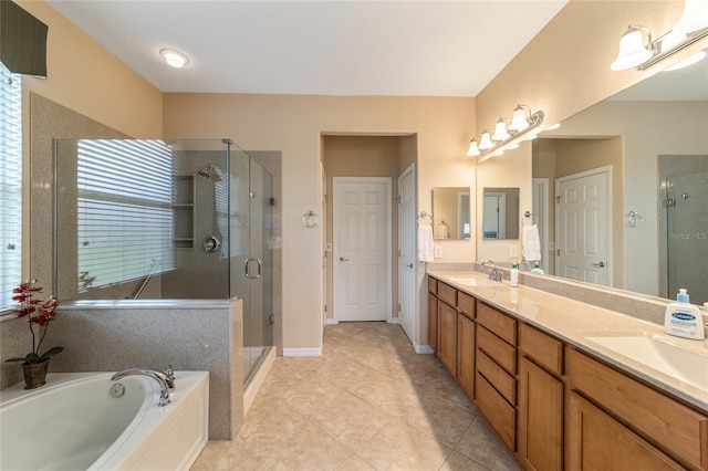 bathroom featuring plenty of natural light, vanity, tile patterned floors, and plus walk in shower