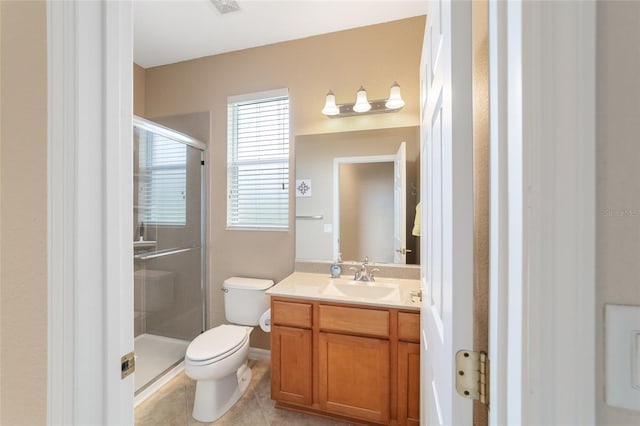 bathroom with vanity, toilet, a shower with shower door, and tile patterned flooring