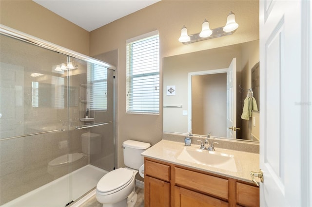 bathroom with vanity, toilet, and walk in shower