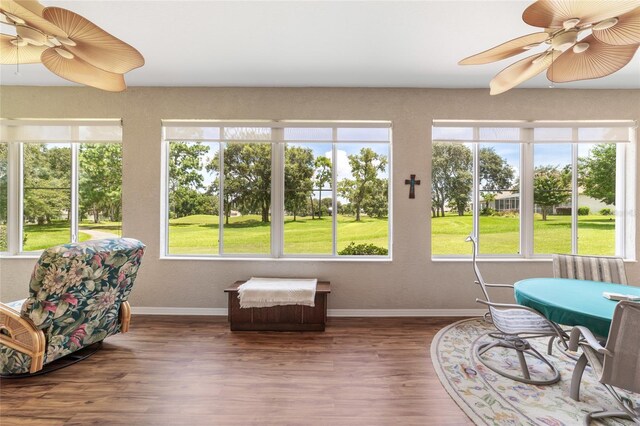 sunroom featuring a healthy amount of sunlight and ceiling fan