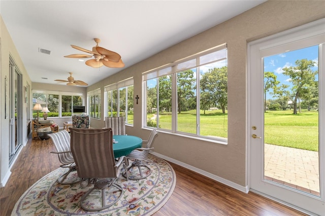 sunroom featuring ceiling fan