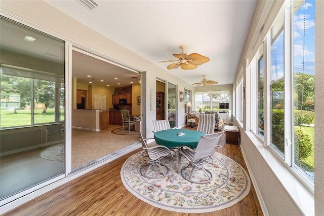 sunroom featuring ceiling fan